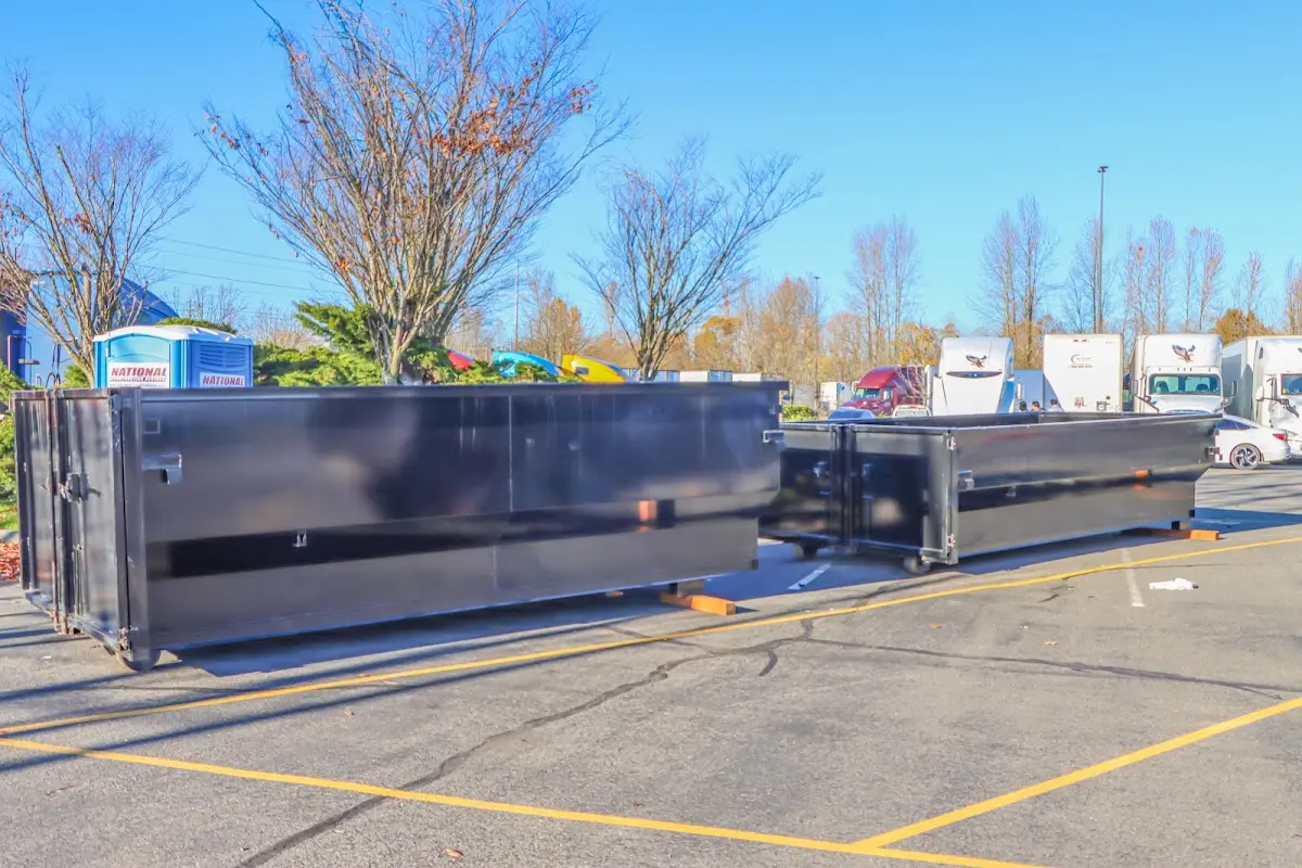 Professional dumpster rental service with roll-off container on residential driveway in Fort Mill